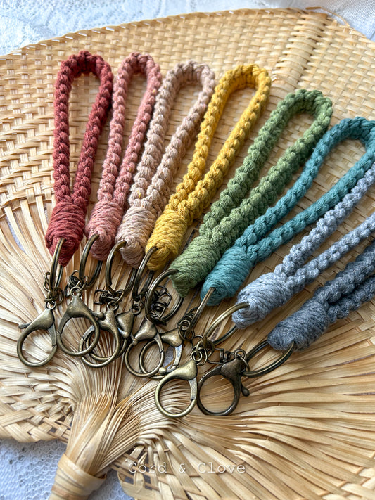 Set of colorful macrame keychains on a woven mat