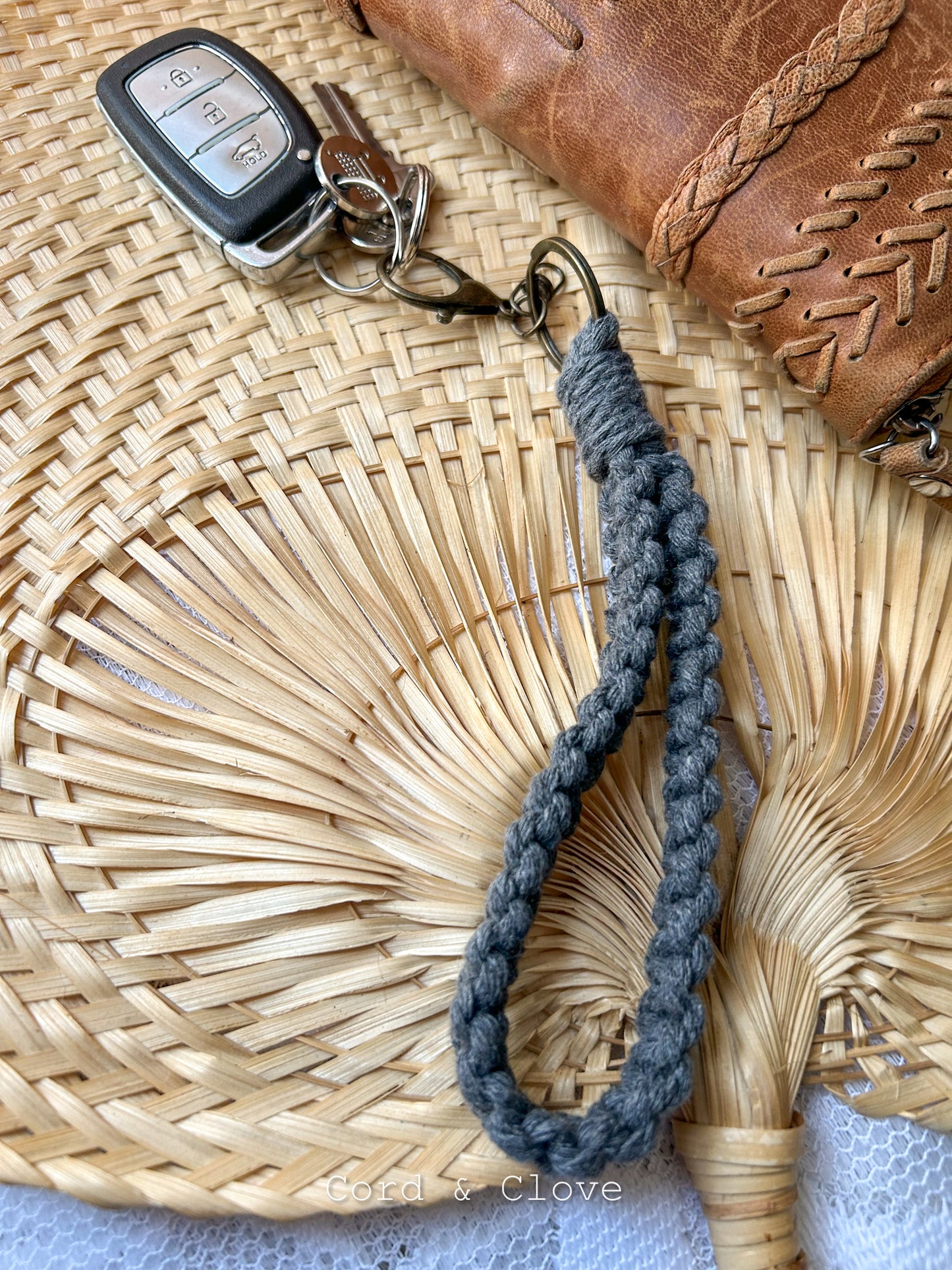 Macrame Keychain with car keys on a woven surface