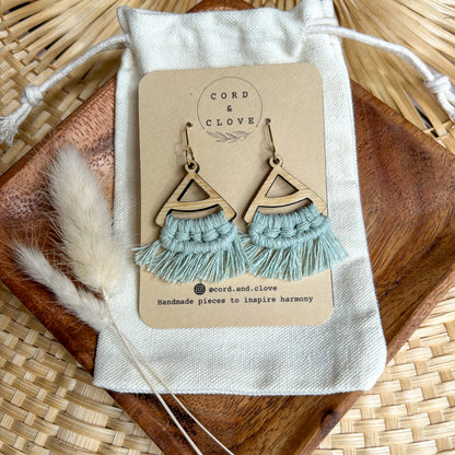 Pair of macrame earrings on a branded card with a natural background